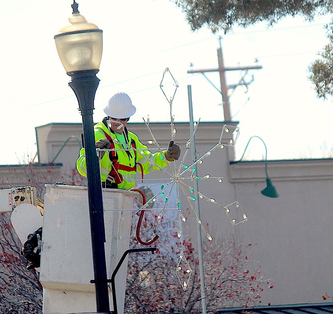 Gardnerville workers were hanging Christmas decorations on Monday.