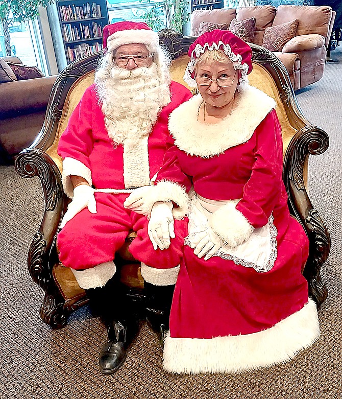 As small business owners themselves, Mr. and Mrs. Claus will turn up in Gardnerville on Saturday . Here they were visiting the Young at Heart Craft Fair. Photo by Kathy Schuman