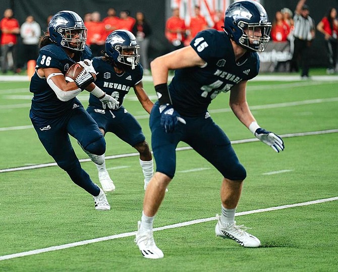 Naki Mateialona (with ball) and Chris Smalley (45) shown against UNLV on Nov. 26, 2022 in Las Vegas.