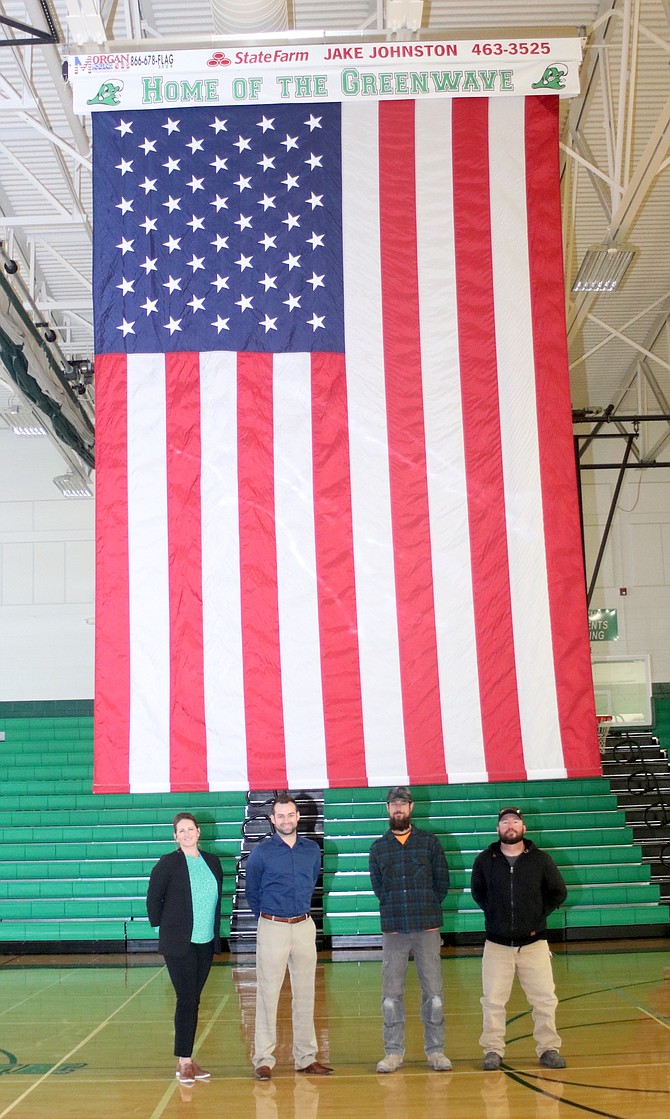 The U.S. flag was recently installed in the Churchill County High School gym. From left are Loni Faught, project coordinator; 2010 CCHS graduate and contributor Jake Johnston of State Farm Insurance in Yerington; Joe McFadden, recently elected school board member and electrician who donated his services; and Dustan Drinkut, school district maintenance supervisor.