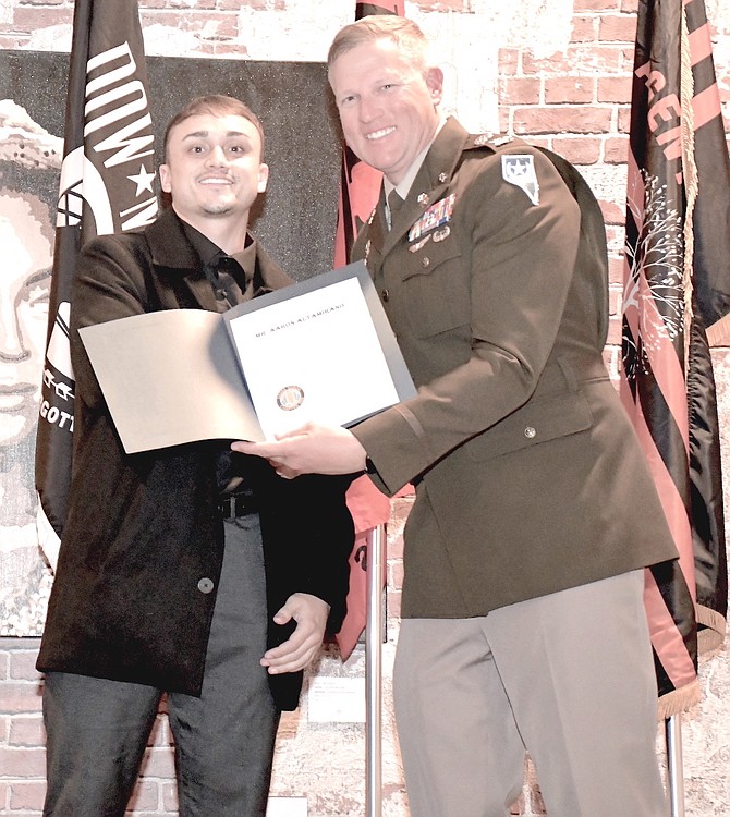 Aaron Altamirano, left, receives his scholarship from Col. John Krueger, Nevada Army National Guard chief of staff.