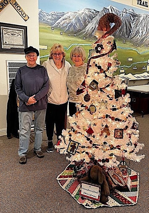 Kathy Meek, Donna Moxley and Lorrie Grannis set up their Carson Valley Quilt Guild Tree at the Carson Valley Museum & Cultural Center in Gardnerville.