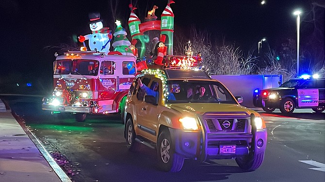 Local businesses, families and agencies drive around Eagle Valley Children’s Home’s roundabout to greet the clients to spread Christmas joy with decorations, lights and music Sunday.
