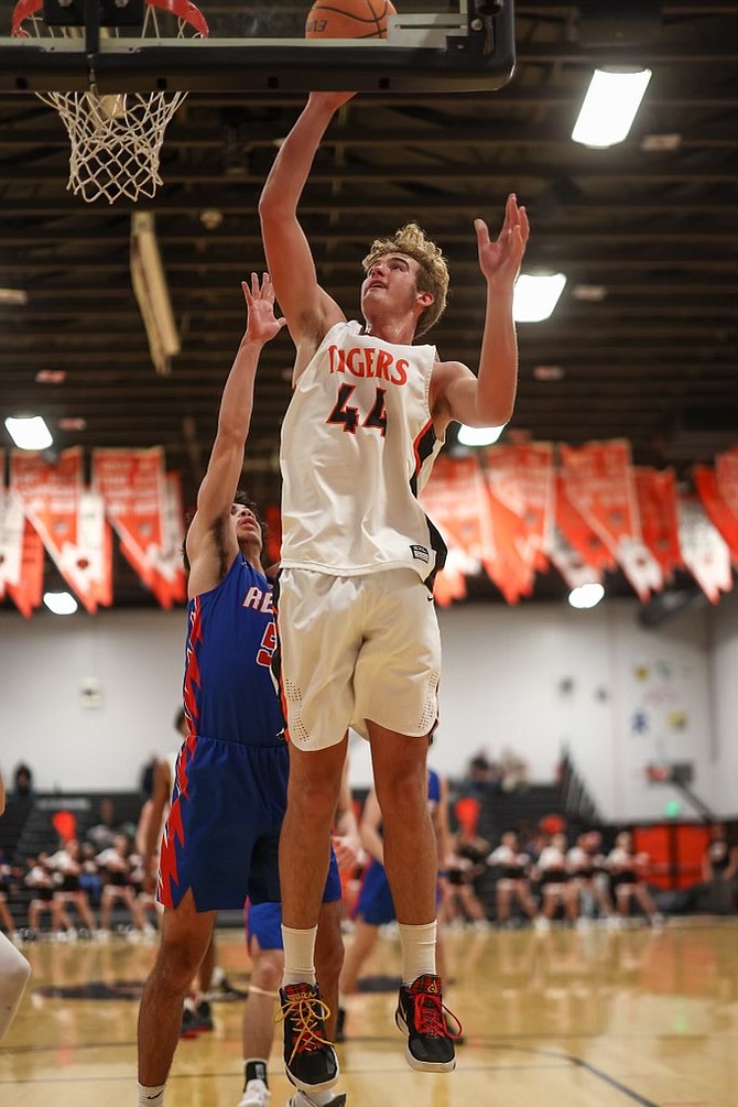 Douglas High senior Jack Tolbert goes up for a bucket off the glass Tuesday against Reno High in the Tigers’ league opener in Minden. Tolbert posted 16 points on 8-of-12 shooting in the home opener.