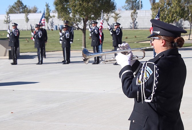 Hannah Little of the Nevada Veterans Coalition plays taps.