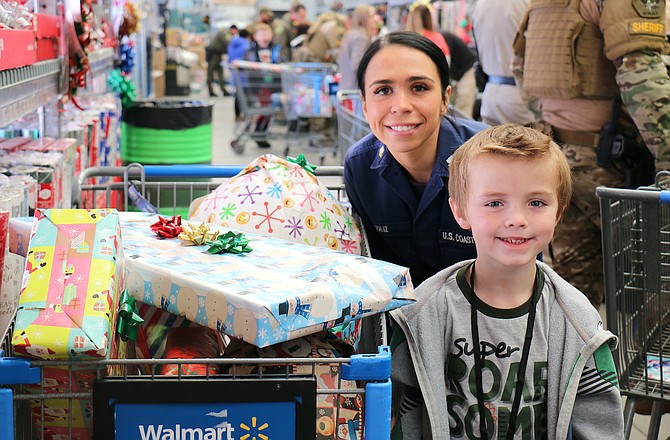 Angelica Soliz, Coast Guard boatswain’s mate second class stationed in Tahoe City, prepared to wrap gifts after shopping with Fremont Elementary School kindergartener Michael Ricci. Soliz has been in the service for eight years.