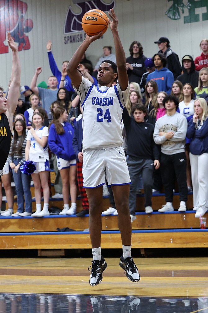 DeCarlo Quintana launches a 3-pointer in front of the Carson High student section Thursday night in a 67-57 win over Galena. Quintana had 27 points, six blocks, six rebounds, three assists and a steal in the 10-point victory.