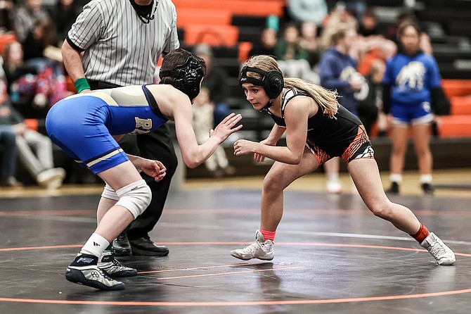 Douglas High freshman, Ella Kavanaugh, circles her opponent from Reed High School Wednesday. Kavanaugh went 2-0 in her home debut for the Tigers at 106 pounds.