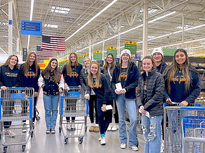 Members of the Douglas High girls varsity basketball squad shop at WalMart for Project Santa Claus. Photo special to The R-C