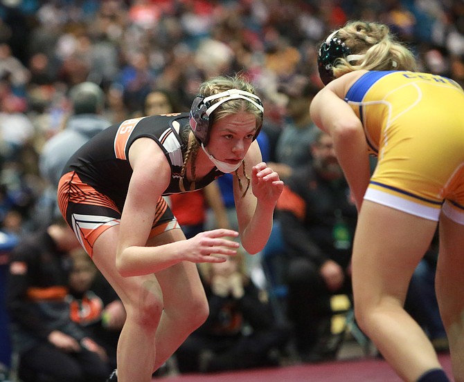 Douglas High School’s Bliss Moody circles her opponent in the opening round of their third place match at 120 pounds. Moody became the first DHS female wrestler to medal at the Reno Tournament of Champions.