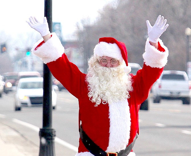 Cars honked as Santa Claus waves to passers-by on Friday in downtown Gardnerville.