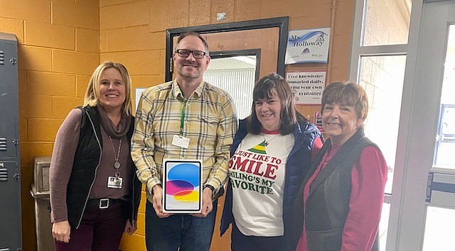 Amy Robinson, Jeremy Batten, Patty Chang and Casey Gilles show an iPad as a prize donated for a drawing sponsored by the Greater Nevada Credit Union.