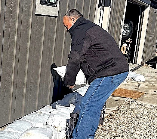 Willow Bend resident Ed Addeo puts sandbags in front of a home near the Carson River in Genoa. Photo by Tara Addeo