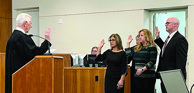 Carson City School Board trustees sworn in by District Court Judge James T. Russell on Friday. From left, Maria Lupe Ramirez, District 1, Molly Walt, District 6, and Matt Clapham, District 3.