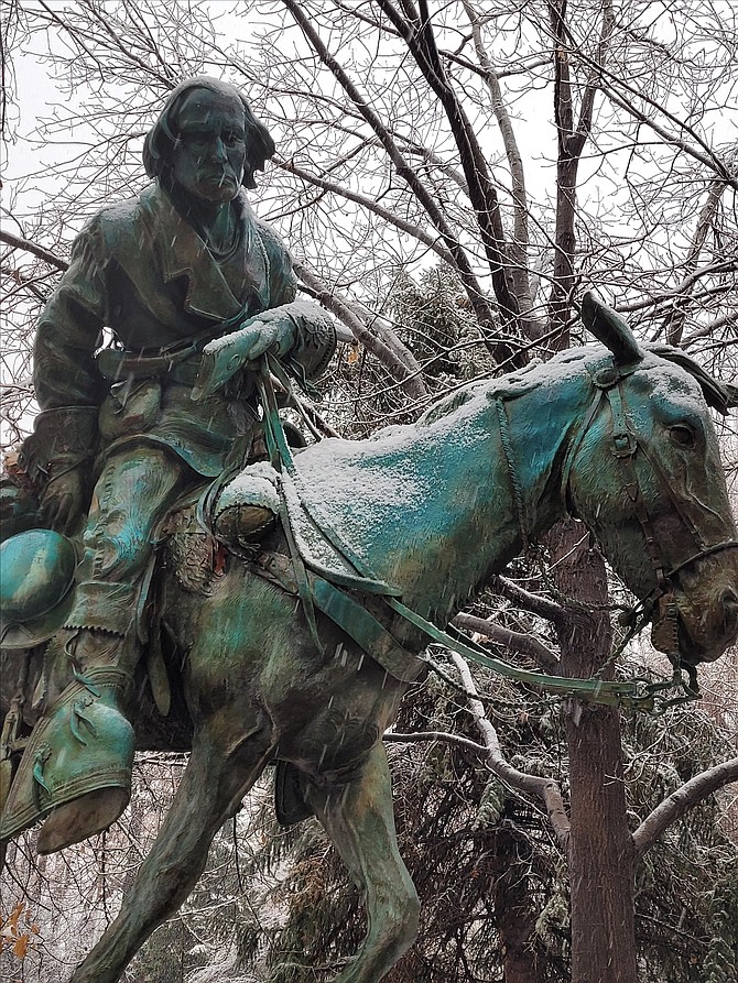 Snow starts to stick on the Kit Carson monument on the Legislative Grounds about 11 a.m. Saturday.