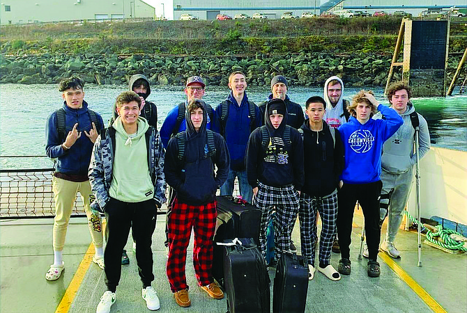 The Eatonville Cruiser boys basketball team poses for a photo before taking a ferry ride from the Ketchikan International Airport last week in Alaska, where the Cruisers were competing in a tournament.
