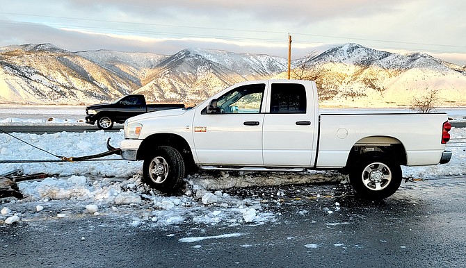 A pickup is hung up in the wire median after spinning out on Highway 395 on Friday morning.