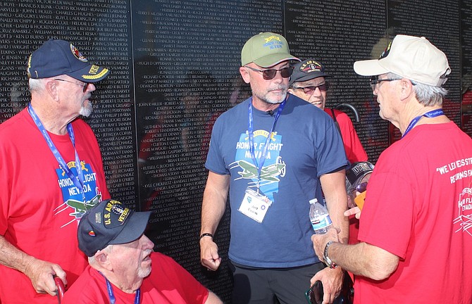 Jeff Evans, center, traveled on an Honor Flight Nevada trip to Washington, D.C. in November as a volunteer. Evans — a Gold Star son, nephew and brother — visited the Vietnam Veterans Memorial with veterans from that era.