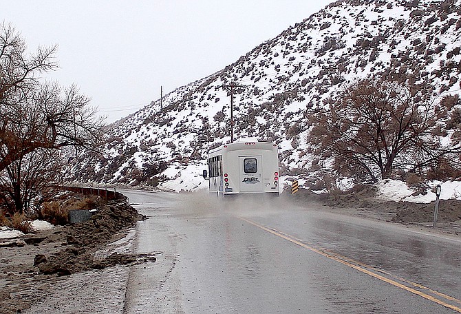 The Douglas Area Rural Transit bus traverses a wet part of Foothill Road on Monday morning.