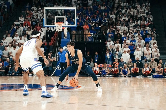 Nevada’s Daniel Foster is guarded by Boise State’s Chibuzo Agbo on Jan. 17, 2023 at Boise, Idaho.