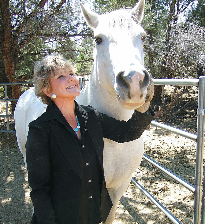 Lacy J. Dalton poses with a horse.