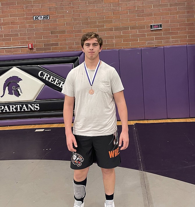 Michael White poses with his medal at the Spring Creek Invitational after taking sixth at the tournament in the heavyweight division over the weekend.