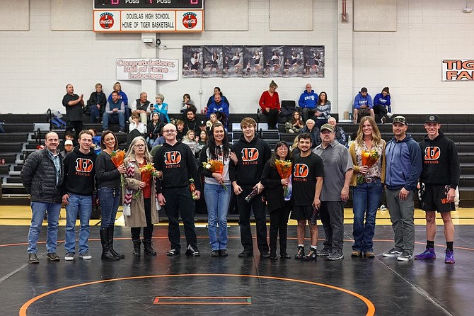 Douglas High’s five seniors pose for a photo alongside their families, during the Tiger wrestling program’s Senior Night celebration. Pictured from left to right are, Jacob Lewis, Donald Jackson, Caine Klein, Victor Valdez and Jaxon Nixon.