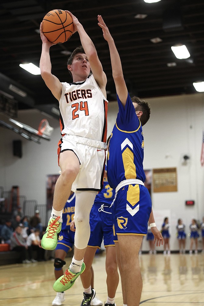 Douglas High junior Jett Lehmann soars through the air on his way to the basket as he put up 15 points Tuesday night in a win over Reed. The 15 points were a season-high for Lehmann.