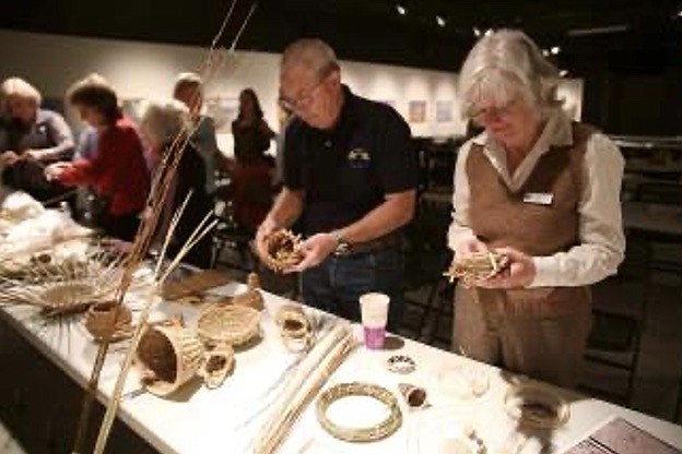 During a recent tour guide training, Nevada State Museum volunteer tour guides Don Dallas and Janice Hoke have hands-on experience with how baskets are made.
