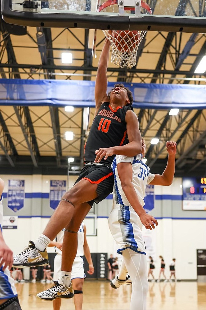Douglas High senior forward Theo Reid slams home a dunk against McQueen on Friday during a 48-42 win. Reid is currently second in the state in blocks with 68 through 21 games.