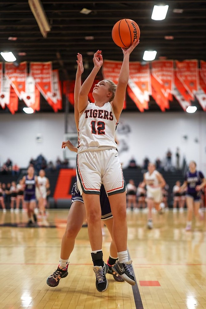 Douglas High’s Ashlyn Greenfield goes up for two points underneath the hoop against Spanish Springs on Friday. The Tigers’ win over the Cougars means Douglas controls its destiny for third place in the Class 5A league standings as the regular season wraps up this week.