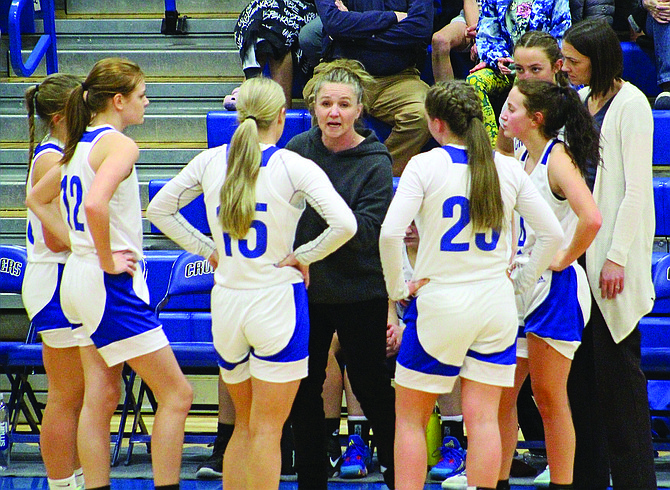 Eatonville girls basketball coach Deanna Andersen instructs her team during a time-out in the Cruisers' game against Hoquiam.