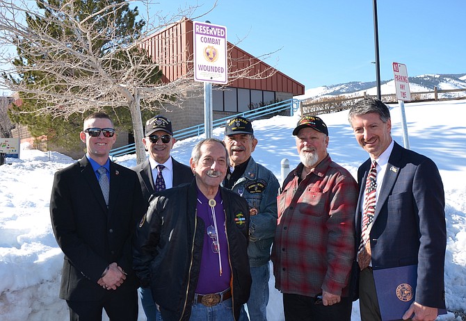 From left, Purple Heart veterans John Jacobson (Afghanistan), Andrew LePeilbet (Vietnam), Ken Santor (Korean), Leonard Munoz (Vietnam) and Tom Spencer (Vietnam) are photographed with WNC President J. Kyle Dalpe at the Purple Heart parking space at WNC on Feb. 8, 2023.