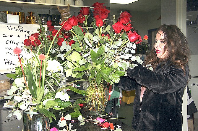 Lori Britton of A Wildflower Florist in Gardnerville arranges some roses in time for Valentines’ Day.