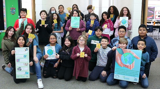 Empire Elementary School’s Green Biz Kids club on Friday celebrates its posters being printed, laminated and distributed among the school’s walls as part of its efforts toward becoming certified as a Nevada green business through the Nevada Green Business Network.