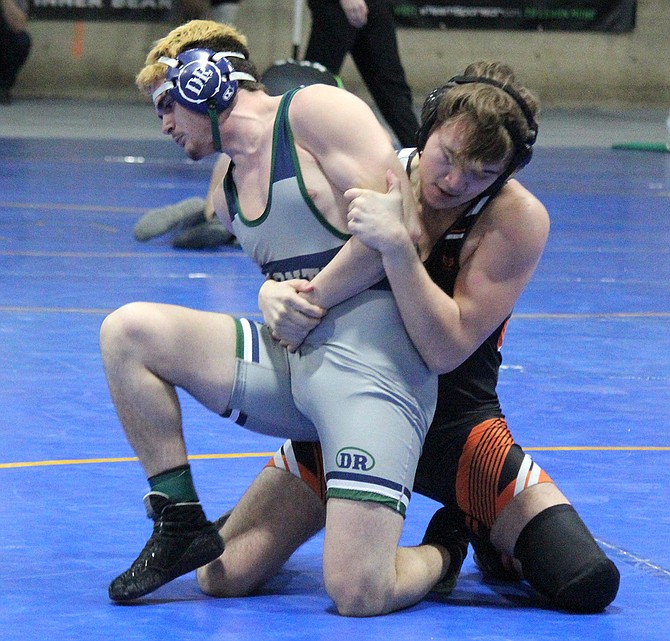 Douglas High’s Caine Klein works for control of Damonte Ranch’s Michael Kiker in the second round of the consolation at this past weekend’s Class 5A state wrestling tournament.
