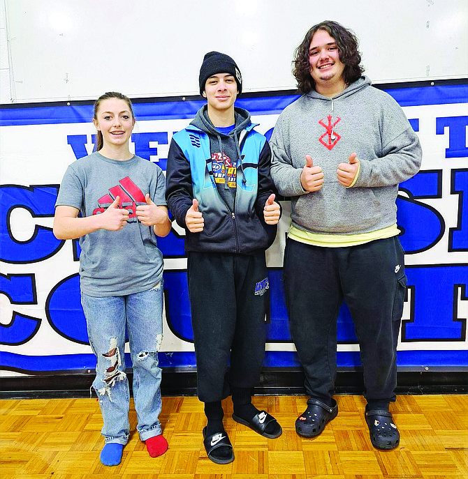 From left: Eatonville’s Ashlynn Kistenmacher, Kasey Whitney and Carsen Pero pose after locking up berths to the state wrestling tournament. The state tournament will take place Friday and Saturday at the Tacoma Dome.