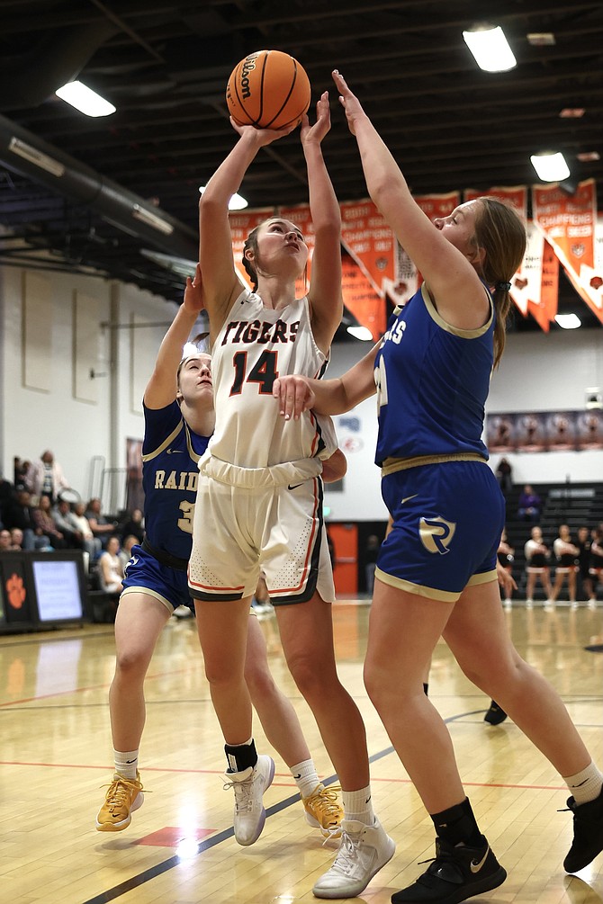 Douglas High's Logan Karwoski turns for an interior basket Wednesday night against Reed. Karwoski had nine points, three rebounds, a steal and a block in the Tigers' blowout win in the opening round of the Class 5A Northern region girls basketball tournament.