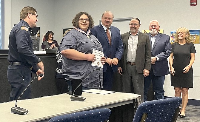 Carson resident Aiden Bailey, center, was awarded the Medal of Commendation for helping his neighbors during a Feb. 21, 2022, house fire during the supervisors’ meeting on Feb. 16, 2023.