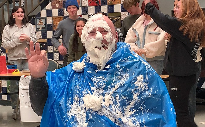 Carson High School social studies teacher Ben Spence gets pied in the face for charity during the school’s Future Business Leaders of America Week.