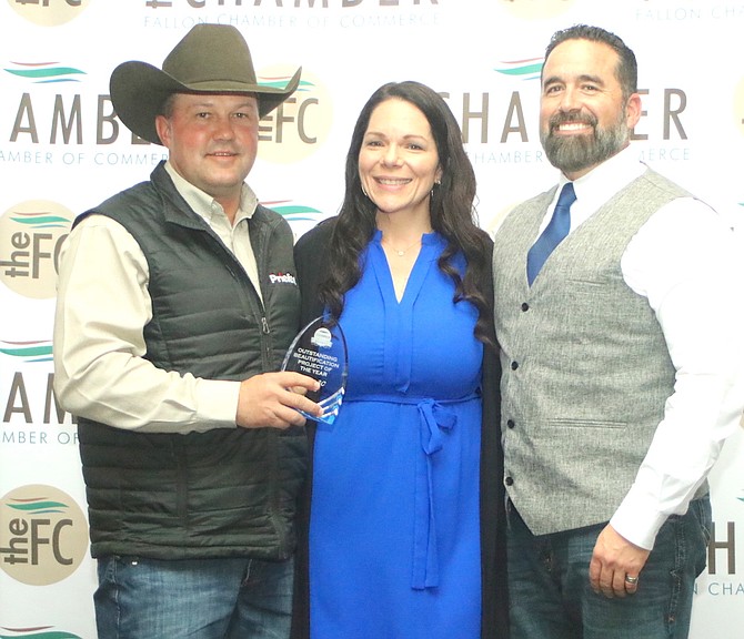 Angela Guthrie, center, a director with the Fallon Chamber of Commerce, awards the Outstanding Beautification Project of the Year to the Rafter 3C Arena. Representing the county were Jesse Segura, left, and Jorge Guerrero.