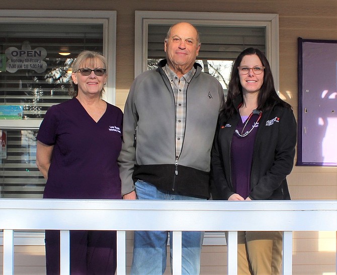 Margie Quirk, left, poses with former owner and founder of Lone Mountain Veterinary Hospital Dr. John Margolin and new owner Dr. Katie Roberts.