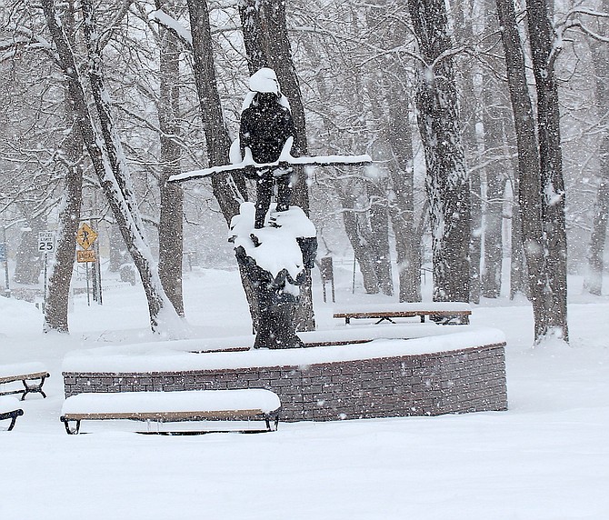 Snowshoe Thompson's statue through the snow on Friday morning.