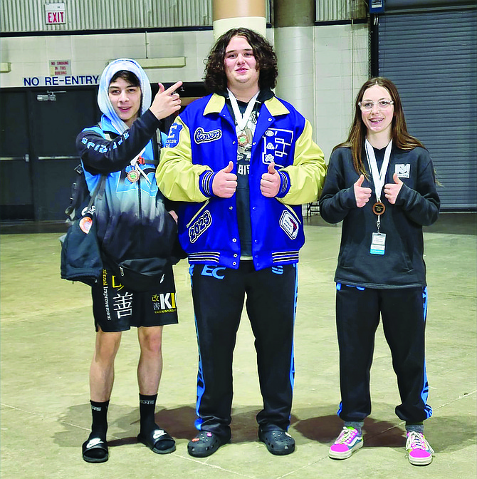 Eatonville wrestlers Kasey Whitney, Carsen Pero and Ashlynn Kistenmacher pose for a photo following their successful day at the state wrestling tournament in Tacoma.
