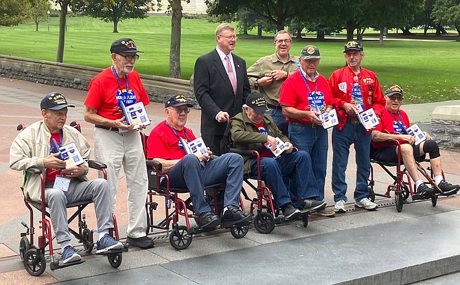 U.S. Rep. Mark Amodei, center, presents the Korean Ambassador for Peace Medal to Korean War veterans on the October Honor Flight Nevada to Washington, D.C. Ernest Heying is third from the left.