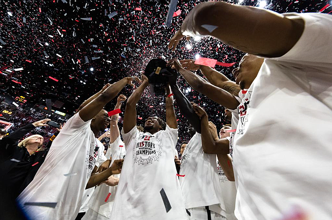 San Diego State’s men’s basketball team celebrates winning the Mountain West Conference title Saturday at Viejas Arena in San Diego.