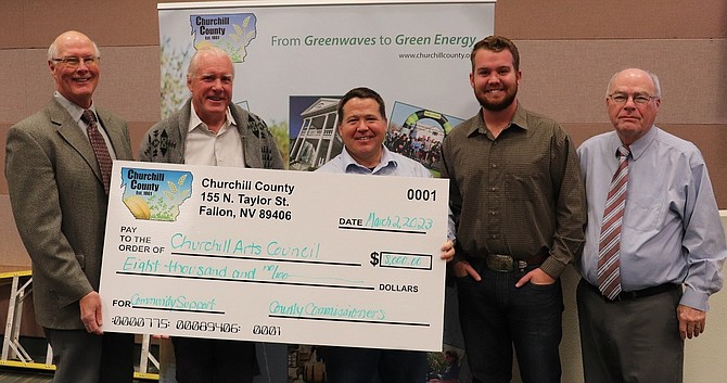 Doug Moore, left, and Tedd McDonald, second from left, representing the Churchill Arts Council, accept a donation from the Board of Commissioners to support operations and programming at the Oats Park Art Center. Also pictured are Commissioners Dr. Justin Heath center, Myles Getto, second from right, and Bus Scharmann, right.