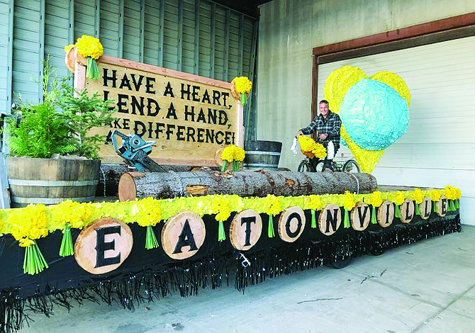 A volunteer works on a Daffodil Festival community float. Coordinators Brad and Sarah Cole are stepping down after three years, and new volunteer float coordinators are needed if Eatonville is to have a float in this year’s parade, April 1.