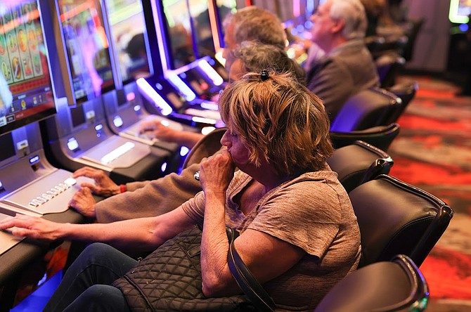 A slot machine player contemplates her next wager at the Wildfire Fremont on Feb. 10.