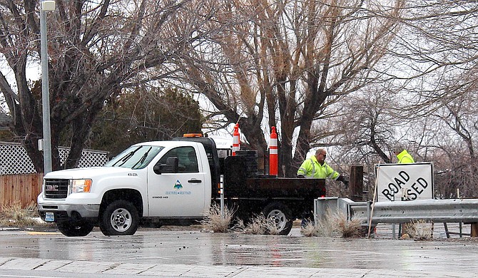A county road crew sets up a closed sign at Centerville and Highway 88 on Friday morning.